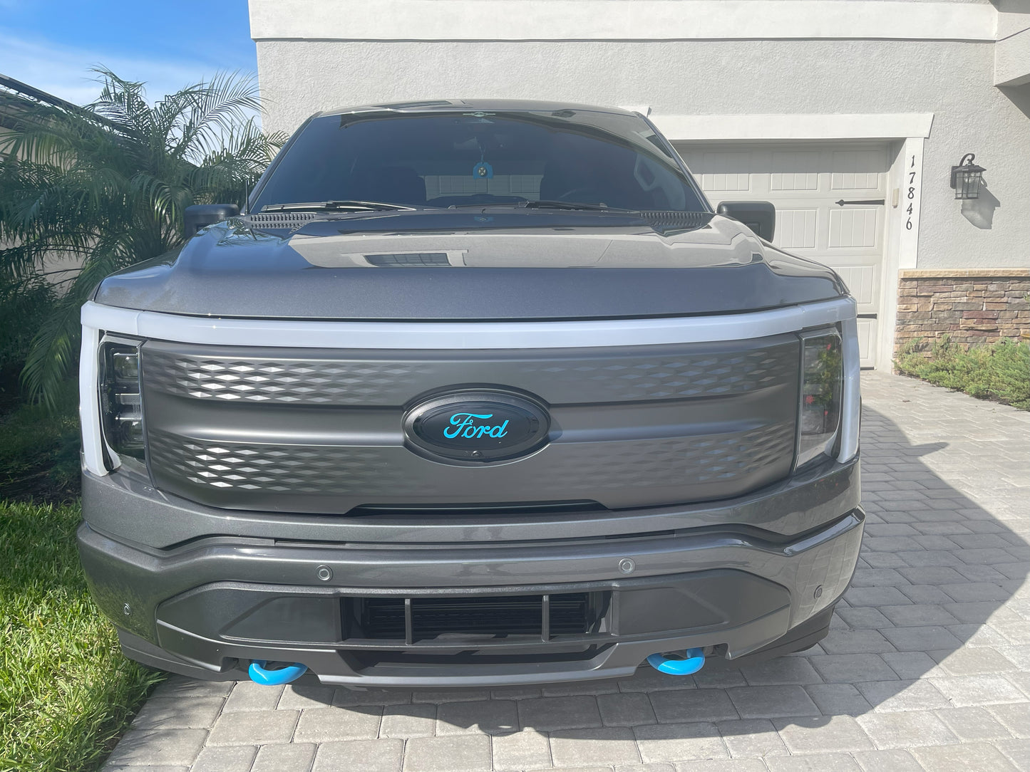 A Carbonized Gray F150 Lightning XLT with Lightning Blue Flex Tow Hook Covers by Tuff Trucks Club.